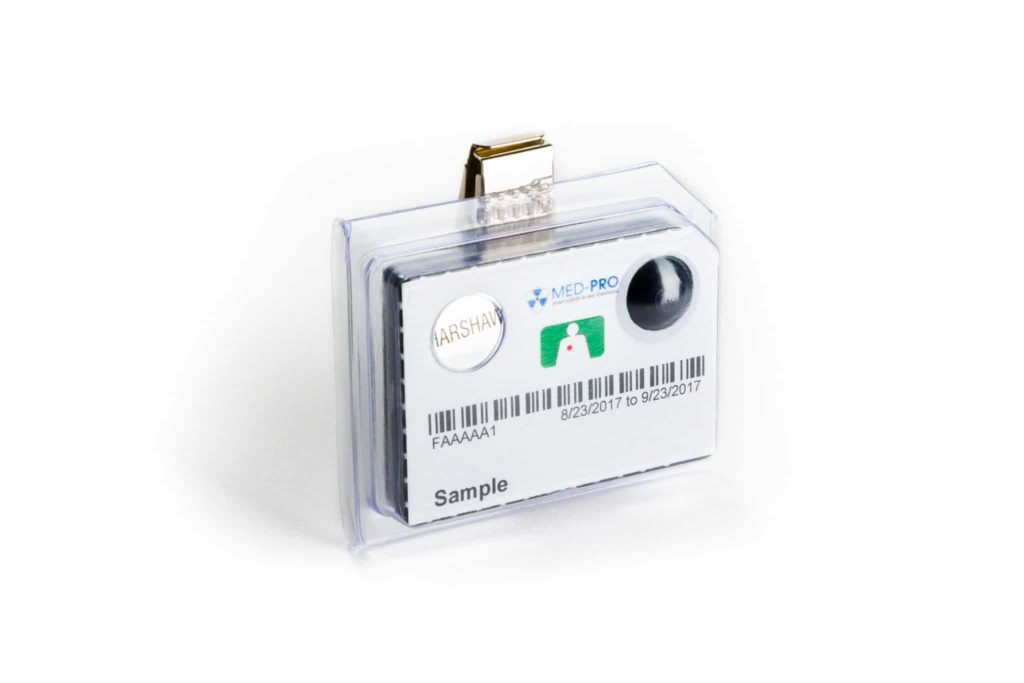 A Harshaw TLD dosimeter radiation monitoring badge. 